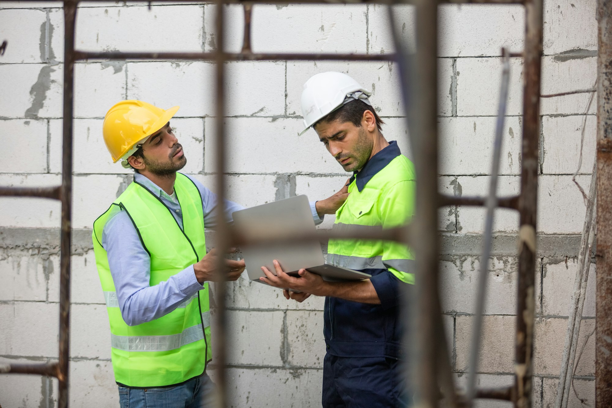 Team engineer builder house construction using laptop check quality building structure.