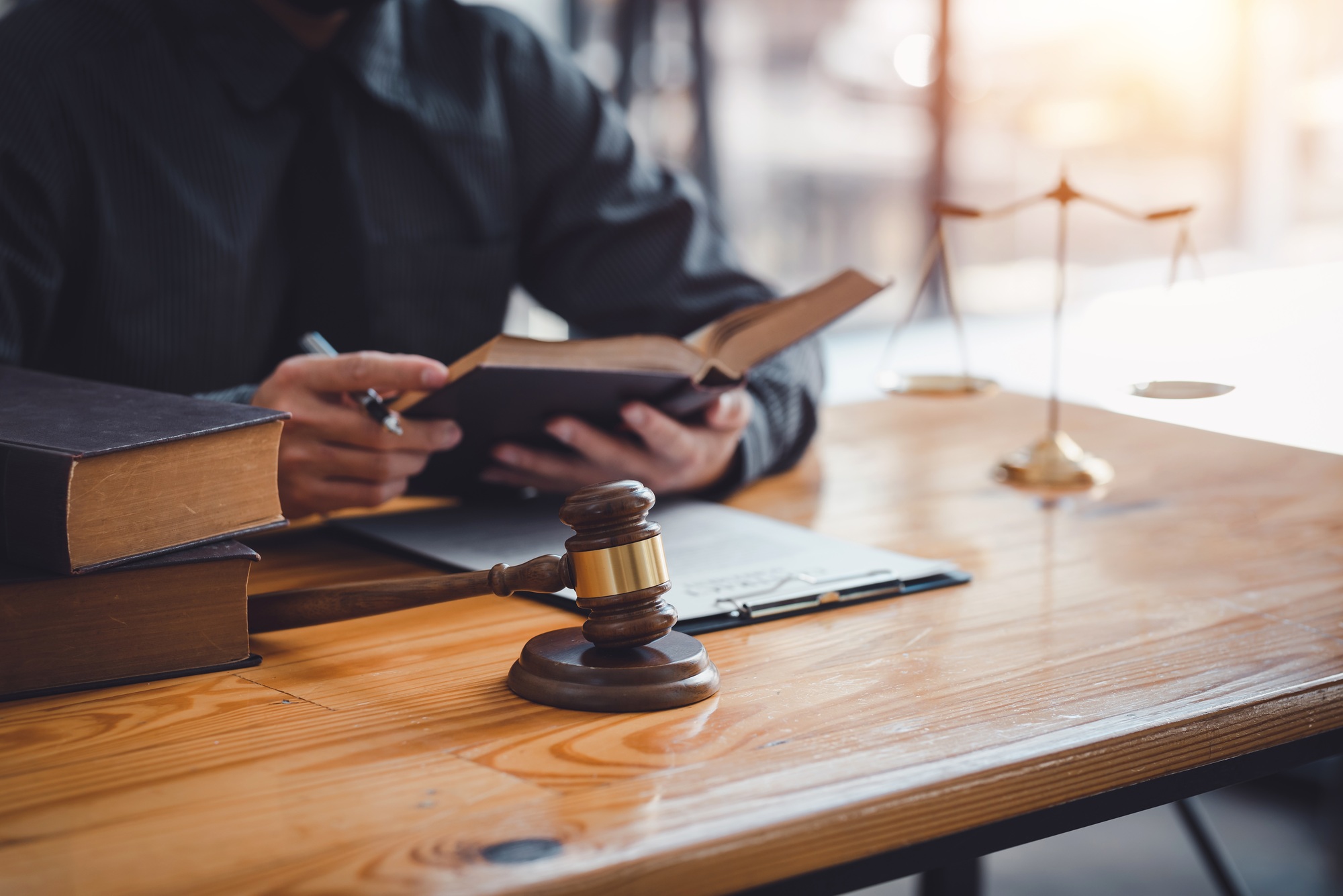 Lawyer working on a document in the office. Legal law, advice and justice concept.
